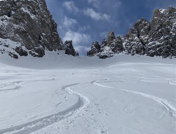 Scenic view of snow covered mountains against sky