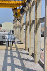 Man walking on road along buildings