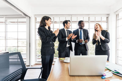 Group of people using laptop on table