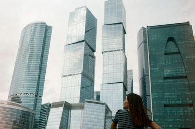 Woman standing against buildings in city