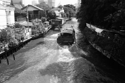 Canal amidst buildings and trees