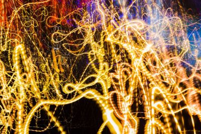 Close-up of illuminated fireworks against sky at night
