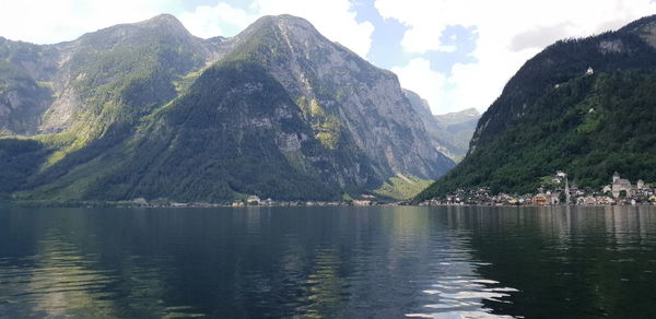 Scenic view of lake and mountains against sky