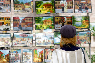 Rear view of a woman by market stall