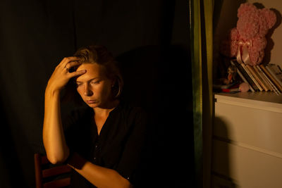 Depressed woman sitting at home