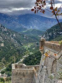 Scenic view of mountain against cloudy sky