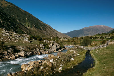 Scenic view of river with mountains in background