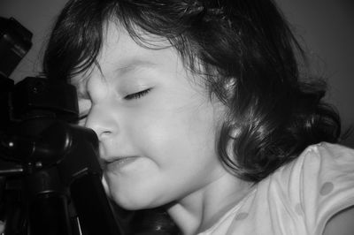 Close-up portrait of cute girl at home