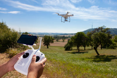 Man flying airplane against sky