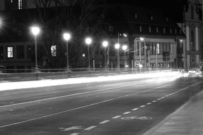 Illuminated city street at night