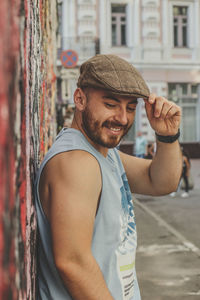 Portrait of young man standing in city