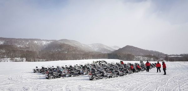 Snowmobiles on land during winter