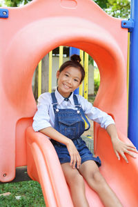 Portrait of girl playing on slide