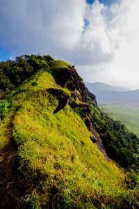 Scenic view of green landscape against sky