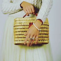 Midsection of woman holding basket