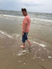 Full length of man on beach against sky