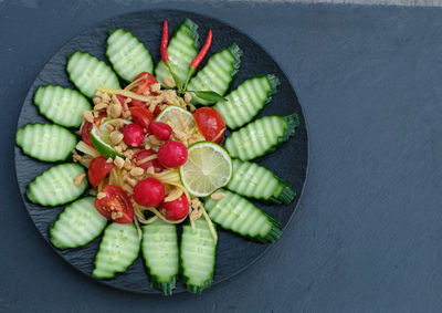 High angle view of chopped fruits in bowl on table