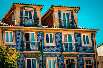 Low angle view of building against blue sky