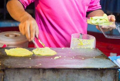 Midsection of person preparing food on table