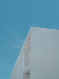 Low angle view of white building against blue sky