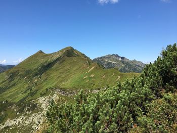 Scenic view of mountains against clear blue sky