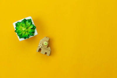 High angle view of green toy on yellow background