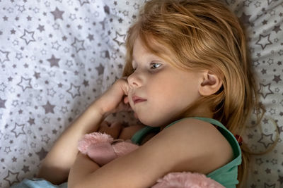 Cute girl lying on bed at home