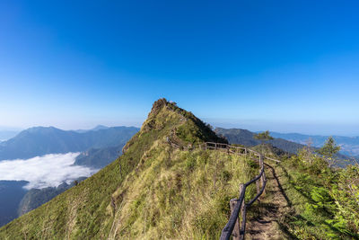 Scenic view of mountains against clear blue sky