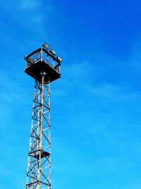 Low angle view of crane against clear blue sky