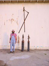 Full length of woman standing on footpath