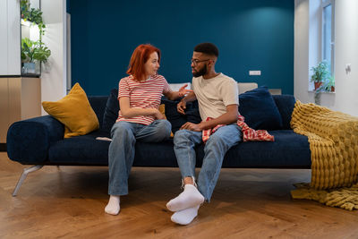 Couple sitting on sofa at home