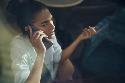 Close-up of young woman using mobile phone