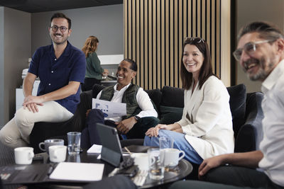 Group of business people having meeting in lobby