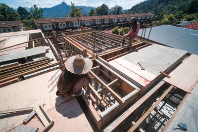 High angle view of man working on roof