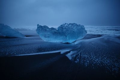 Scenic view of frozen sea against sky at night