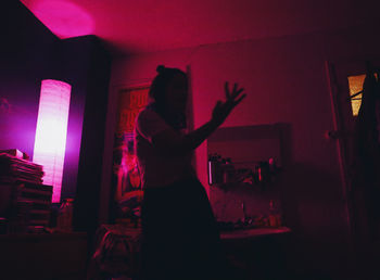 Side view of silhouette woman standing at home
