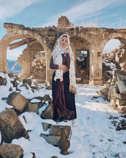 Portrait of woman standing in snow