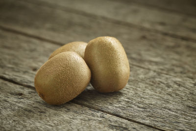 High angle view of kiwis on wooden table