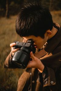 Young man photographing outdoors