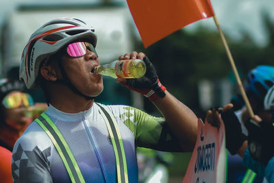 Midsection of man drinking water from bottle