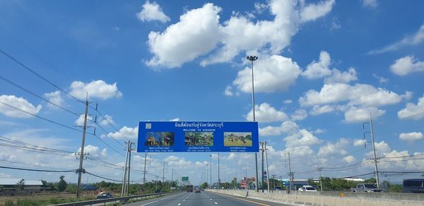 Road sign against sky