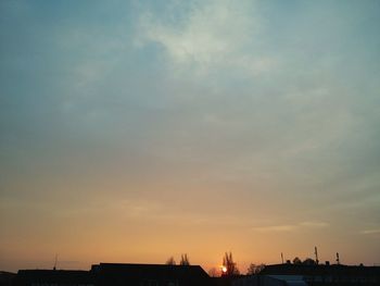 Low angle view of silhouette built structures against sky
