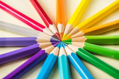 Close-up of multi colored pencils on table