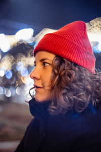 Curly young woman at night at the fair