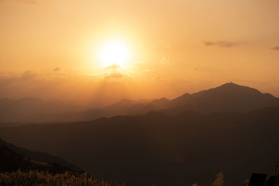 Scenic view of silhouette mountains against sky during sunset