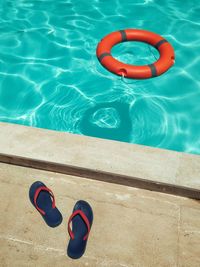 High angle view of shoes floating on swimming pool