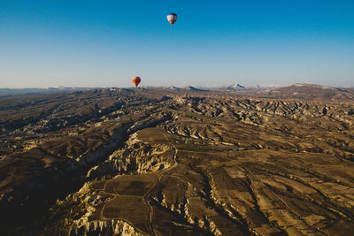 Hot air balloon flying over mountain