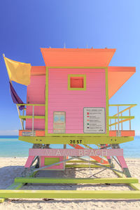 Lifeguard hut on beach against sky