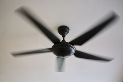 Low angle view of electric lamp hanging on ceiling at home