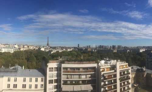 High angle view of buildings against blue sky